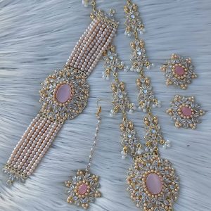 bridal jewelry set featuring a necklace, choker, earrings, and a maang tikka