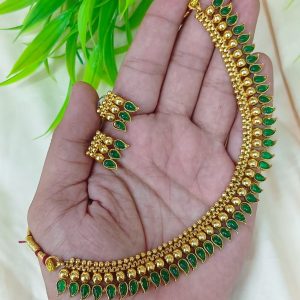 appears to be a traditional South Indian style gold-plated temple jewelry se