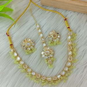 ndian-style antique Kundan jewellery set includes a necklace, earrings, and a maang tikka,