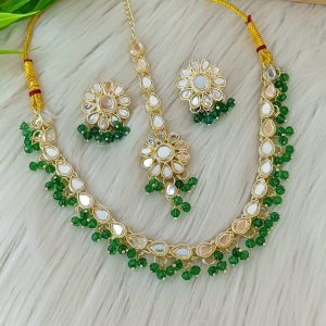 ndian-style antique Kundan jewellery set includes a necklace, earrings, and a maang tikka,