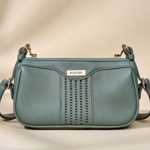 green faux leather women’s sling or cross-body bag.