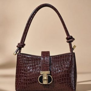 Sandro Janet leather shoulder bag in a bordeaux or dark red color.