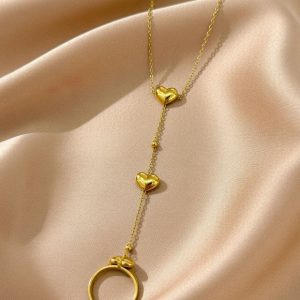 gold-plated heart pendant necklace, featuring multiple heart charms and a long chain.
