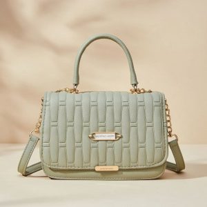 women’s quilted top handle crossbody bag in a light green or sage color.