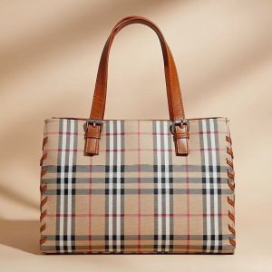 Burberry Check tote bag in a coated cotton blend with leather trim.