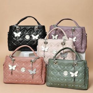 ladies’ quilted top-handle bags with butterfly charms, available in black, pink, beige, and green colors.