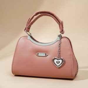 pink top-handle satchel bag with a heart-shaped charm