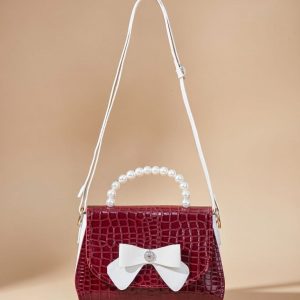 red crocodile pattern women’s shoulder bag with a bow accent.